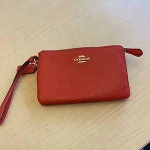 Coach pebbled leather double corner zip wristlet in mango. Brand new never used.